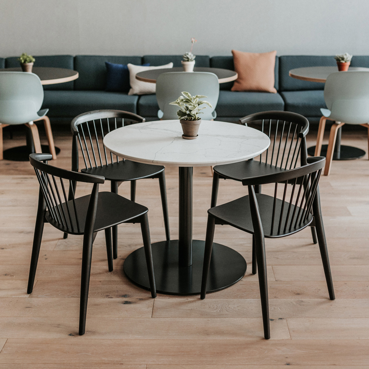 Four chairs surrounding a circular table